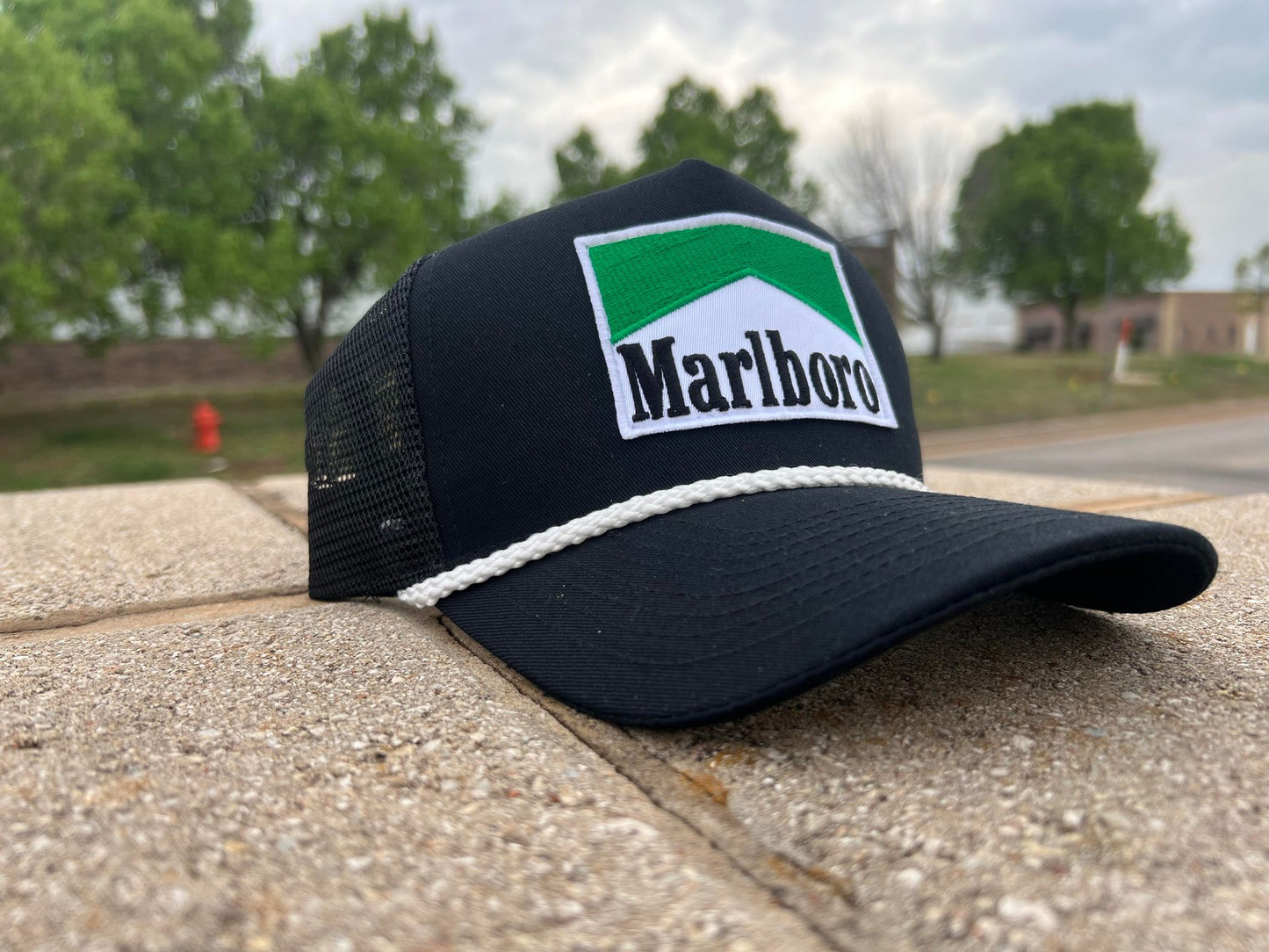 a marlboro trucker hat sitting on a ledge