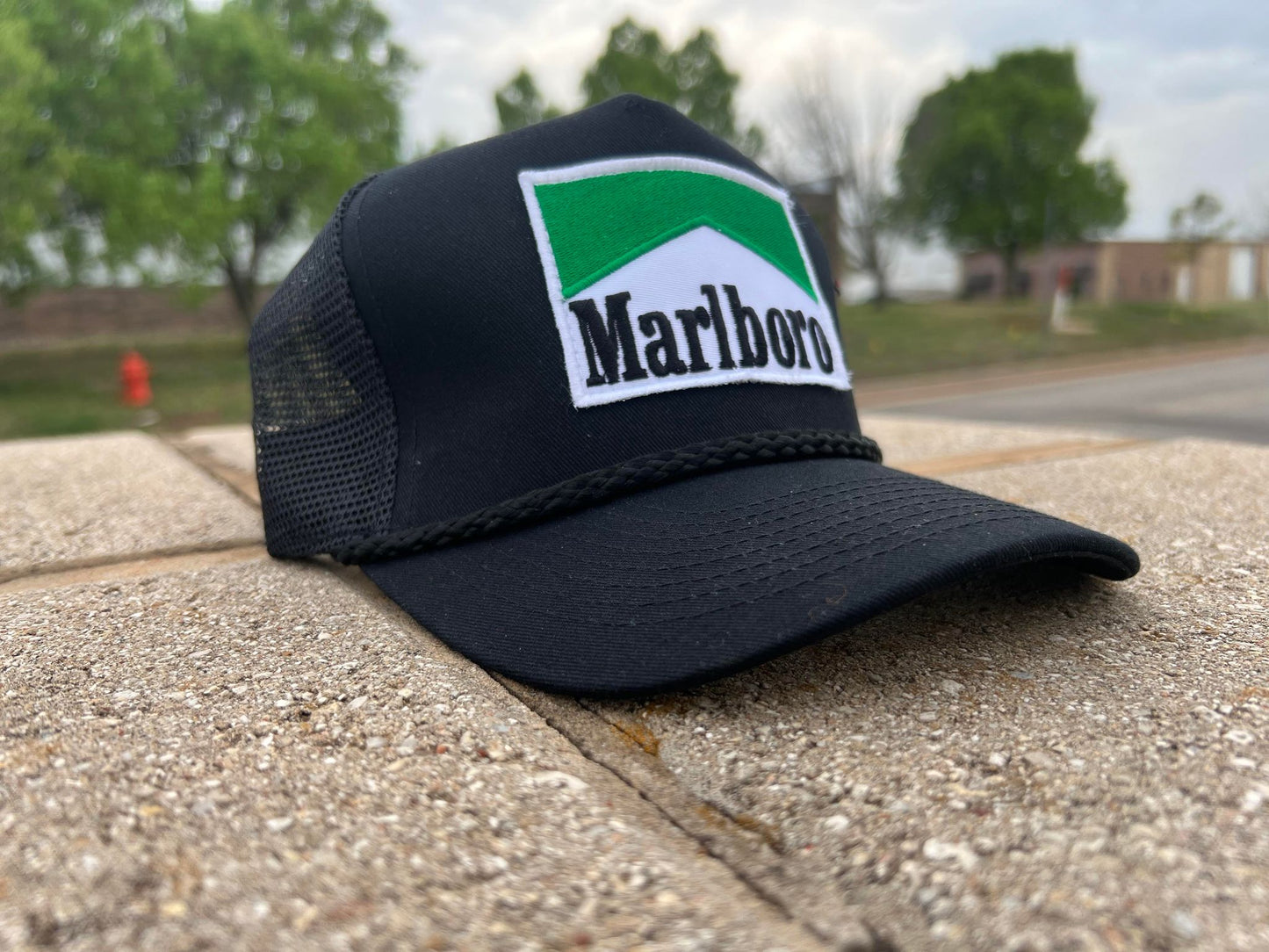 a marlboro trucker hat sitting on a ledge