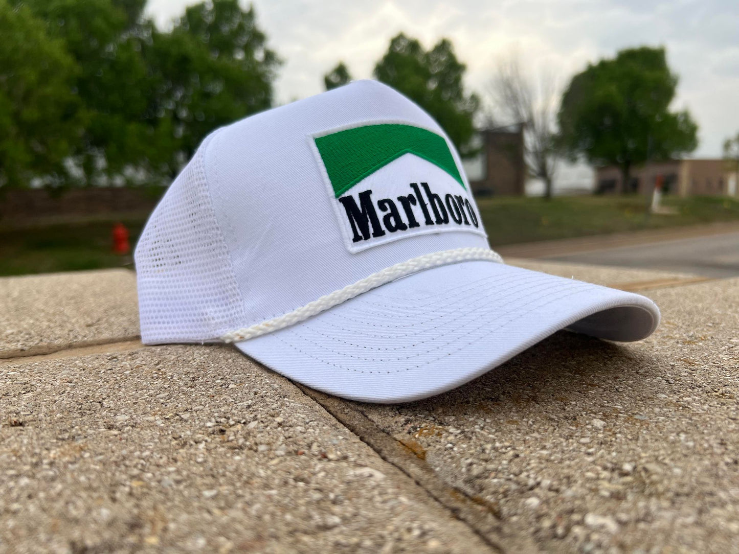 a marlboro hat sitting on the side of a road