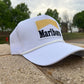 a marlboro hat sitting on the side of a road