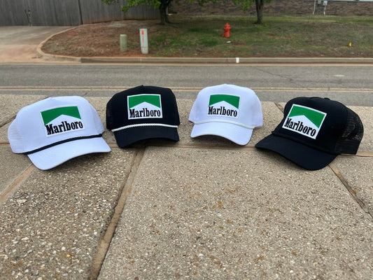 three hats sitting on the side of a road