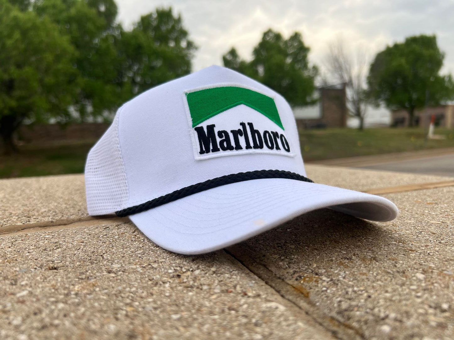 a marlboro hat sitting on top of a stone wall