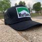 a marlboro trucker hat sitting on a ledge